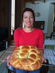 Woman holds freshly baked Challah bread