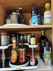 Stacked and a single shelf lazy Susan keep kitchen spices and oils in order